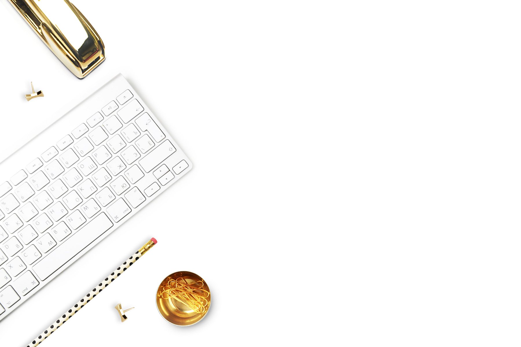 Flat lay, office white desk and keyboard with gold stationery.